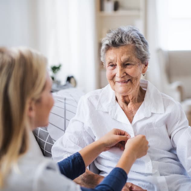 Elderly woman with caregiver — compassionate care that comes from the heart